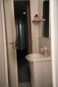 a bathroom with a white sink and a mirror at FiordalisoHouse-Stadio Olimpico in Turin