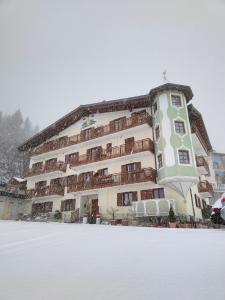 a large building with snow in front of it at Appartamenti La Val in Andalo