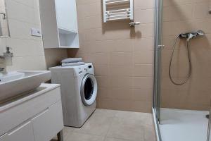 a bathroom with a washing machine and a shower at Apartmán Soul 200 m do centra s private parking in Košice