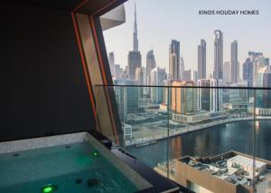 a view of a city from a room with a hot tub at binghatti canal , burj Khalifa view with private jacuzzi and cinema screen ,KINGS in Dubai