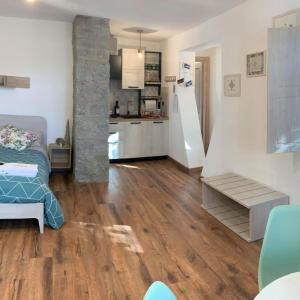 un salon avec parquet et une cuisine dans l'établissement Casa della montagna apartament, à Lorica