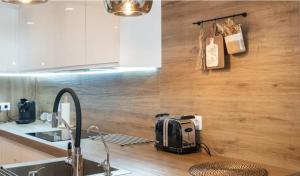 a kitchen with a toaster sitting on a counter at Apartamento Boutique Miramar Playa, Garaje opcional in Fuengirola