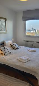 a bedroom with a bed with two towels on it at Apartment Blessing in Zagreb