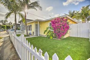 a yellow house with a white fence and pink flowers at Gorgeous Pacific Beach and Mission Bay Home. Walking distance to the Bay and Golf Course. in San Diego