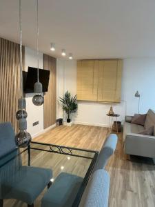 a living room with a couch and a glass table at Villa Emérita in Vigo