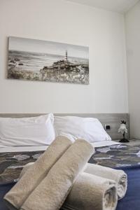 a bedroom with a bed with towels on it at Pensione Sorriso in Vernazza