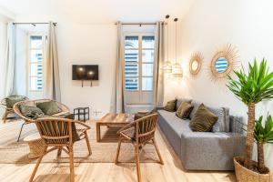 a living room with a couch and chairs and a table at Les Suites de l'Opéra appartement Barbara 10 pers in Lyon