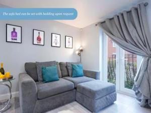 a living room with a couch and a window at Stylish Apartment - Close to the City Centre - Free Parking, Fast Wi-Fi and Smart TV with Netflix by Yoko Property in Aylesbury