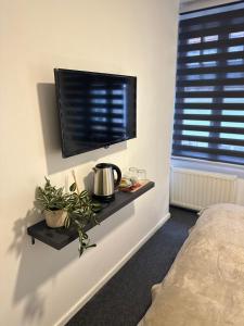 a bedroom with a flat screen tv on a wall at Royal Moon Suites in Sarajevo