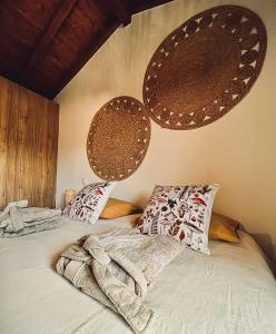 a bed with blankets and pillows on top of it at Pura Vida Matos House in Fafião