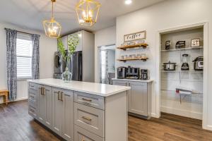 a kitchen with white cabinets and a counter top at Chic Indianapolis Home with Patio Less Than 2 Mi to Downtown in Indianapolis