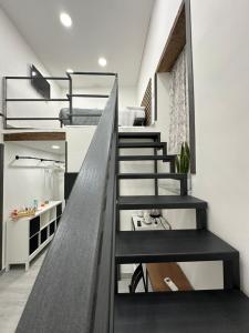 a staircase leading up to a loft with bunk beds at Casa Di Lorenzo in Naples