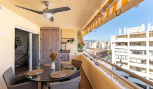 a balcony with a table and chairs with a view at Apartamento Boutique Miramar Playa, Garaje opcional in Fuengirola