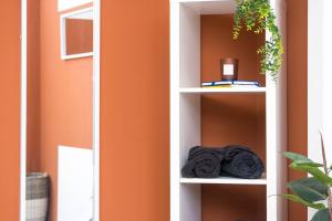 a white book shelf with towels on it at Sleek Urban Living with Bicocca Stays in Aberdeen