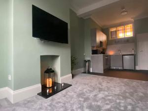 a large living room with a flat screen tv on the wall at Hidden in plain sight in Kent