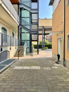 an empty courtyard of a building with a staircase at Luxury Four-Room Apartment in Monza Centro - 2 min walk to Train Station in Monza