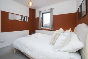 a bedroom with a white bed and a window at Sleek Urban Living with Bicocca Stays in Aberdeen