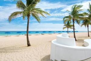 a beach with palm trees and the ocean at Perfect Beach Escape 1BD/1Bath Close to Everything in Fort Lauderdale