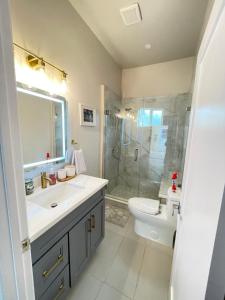 a bathroom with a sink and a shower and a toilet at Van Nuys Luxury, near to Universal Studios, and Hollywood in Los Angeles