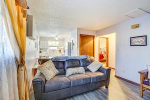 a living room with a couch and a kitchen at Downtown Pierre Apartment about half Mi to River! in Pierre