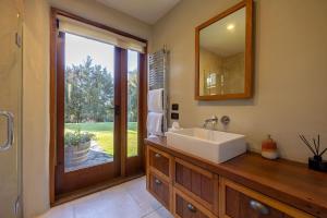 a bathroom with a sink and a mirror at Lake Hawea View in Albert Town +47 photos
