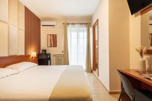 a bedroom with a large white bed and a desk at AlbaDomus Affittacamere o GuestHouse in Rome +18 photos