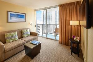 ein Wohnzimmer mit Couch und großem Fenster in der Unterkunft Waikiki Resort Hotel in Honolulu