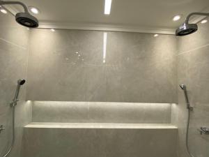 a bathroom with a shower with two lights on it at Ninety Suíte Premium in Sao Paulo