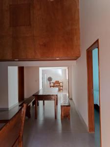 a dining room with a table and chairs and a table and a dining room at Caravelas casa de Abrolhos in Caravellas +36 photos