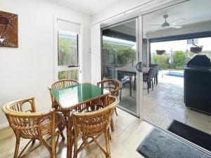 a dining room with a table and chairs at Waiheke Marina Getaway in Shellharbour