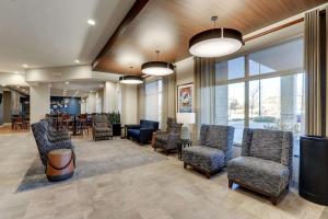 a waiting room with chairs and tables and windows at Drury Plaza Hotel Denver Westminster in Westminster