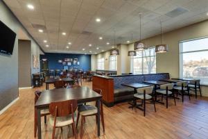 a restaurant with tables and chairs and a bar at Drury Plaza Hotel Denver Westminster in Westminster