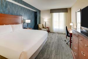 a hotel room with a large bed and a desk at Drury Plaza Hotel Denver Westminster in Westminster