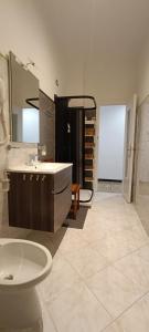 a bathroom with a sink and a toilet and a mirror at Costa ligure in Albissola Marina