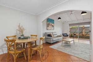 a living room with a table and chairs and a couch at NORM3/17 - Little Hacienda in Perth