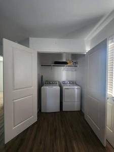 a laundry room with two washes and a door at Angelic in Elgin