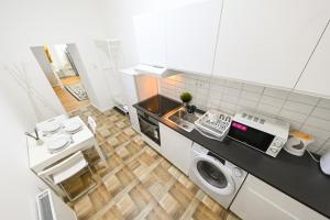 a kitchen with a sink and a washing machine at Charming apartment in Damjanich str., Lucas in Budapest