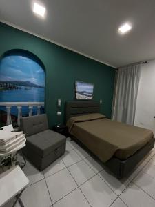 a bedroom with a bed and a couch and a window at Bed & Breakfast De Bono in Naples