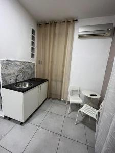 a kitchen with a sink and a table and chairs at Bed & Breakfast De Bono in Naples +23 photos