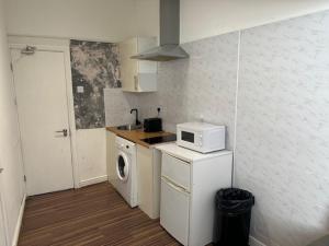 a small kitchen with a microwave and a washer at All Seasons Central Manchester in Manchester