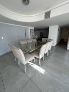 a dining room with a glass table and chairs at Casa Barrio Bombal in Mendoza