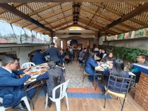 a group of people sitting at tables in a restaurant at Hotel Boutique Casa José in Cobán