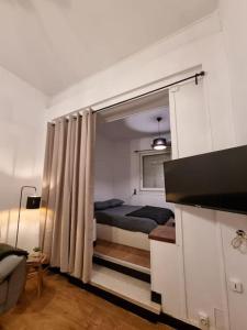 a small bedroom with a bed and a window at Chez Sam in Saint-Laurent-de-la-Salanque