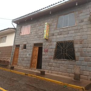 a brick building with two doors on a street at VILLA MARAS Hotel in Maras