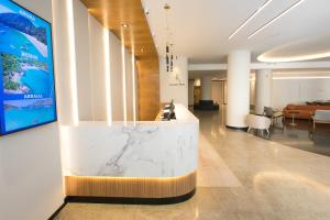 una hall con un bancone in marmo al centro di Regency Park Hotel - SOFT OPENING a Rio de Janeiro