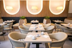 a restaurant with tables and chairs and lights at Regency Park Hotel in Rio de Janeiro