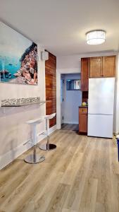 a kitchen with a table and a refrigerator at Winnipeg Holiday in Winnipeg