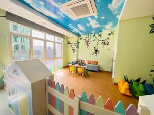 a childs room with a ceiling painted with clouds at Comfy studio room in Bacolod