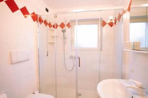 a bathroom with a shower and a toilet and a sink at Sun & Mountains Cavalese in Cavalese