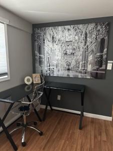a room with a desk and a wall with a painting at Cozy Spacious Guest Suite in Englewood
